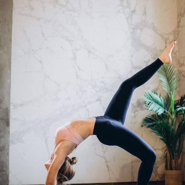 Person feeling energized and stretching arms upwards against a dark background.